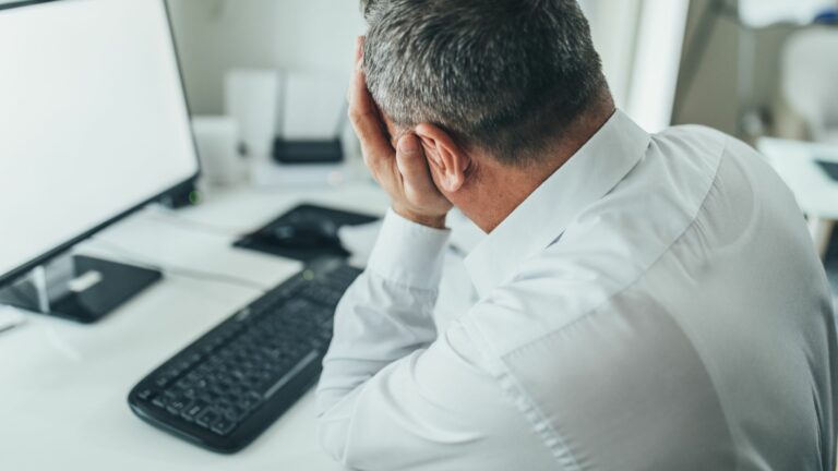 Man sitting at computer frustrated