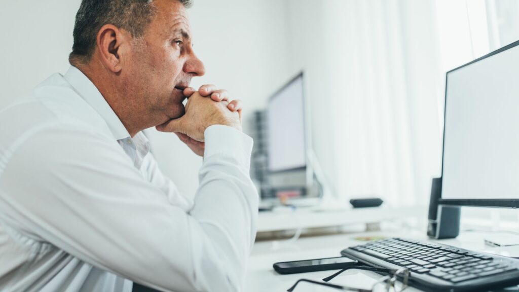 Man looking concerned at computer screen