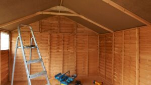 Inside of a new shed with ladder and toolbox, illustrating successful contractor marketing.
