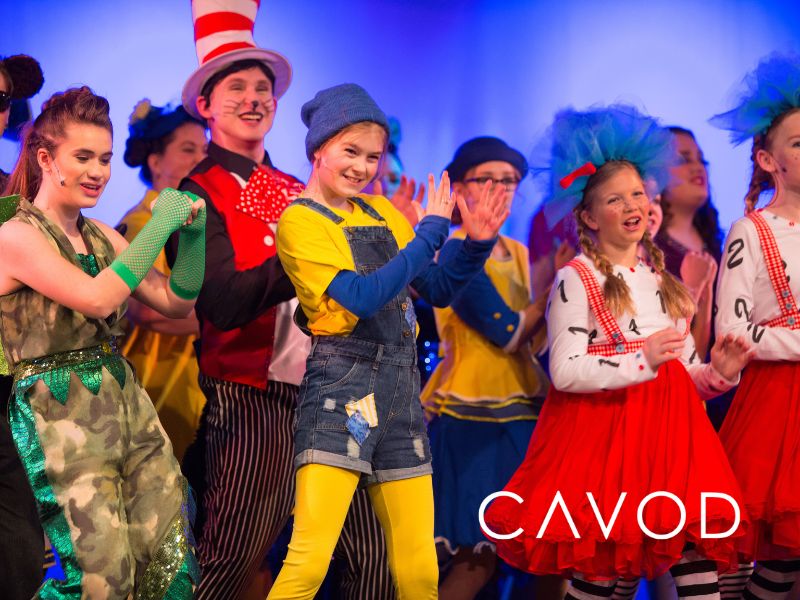 Actors performing on stage during a live theater production promoted through digital marketing for performing arts